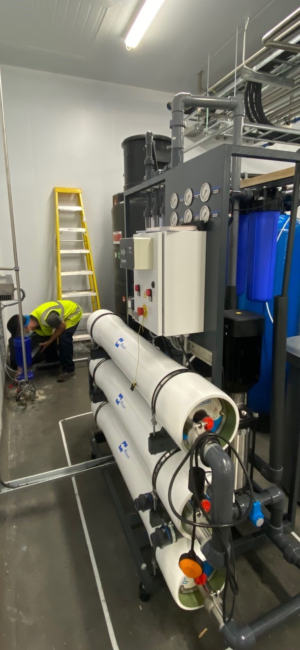 Engineer servicing Reverse Osmosis machinery in a bottling plant in Sunderland.