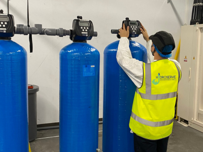 Service engineer doing maintenance on a Water System in a Commercial setting.