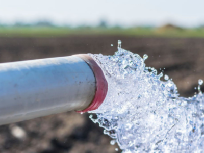 Water gushing from a ground water pipe.